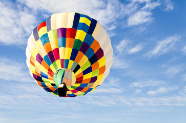 Colorful hot air balloon flying over blue sky