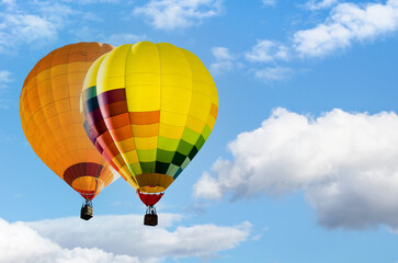 Colorful hot air balloon flying over blue sky