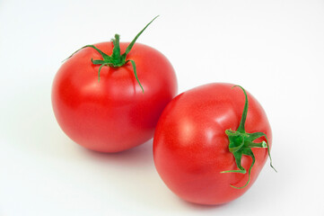 ripe tomatoes on a white background. the concept of cooking tomato sauce. red vegetables on a light texture. juicy pink tomatoes on the table