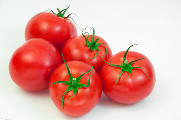 ripe tomatoes on a white background. the concept of cooking tomato sauce. red vegetables on a light texture. juicy pink tomatoes on the table