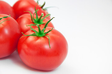 ripe tomatoes on a white background. the concept of cooking tomato sauce. red vegetables on a light texture. juicy pink tomatoes on the table