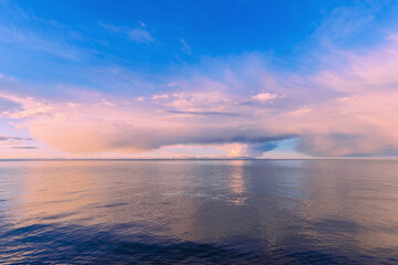 Fototapeta na wymiar Landscape with sunset cloudy skies on the lake