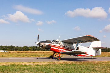 Small aircraft with propeller in parking lot.