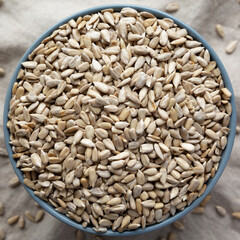 Raw Organic Sunflower Seed Kernels in a Blue Bowl, top view. Flat lay, overhead, from above. Close-up.