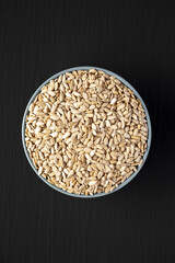 Raw Organic Sunflower Seed Kernels in a Blue Bowl, top view. Flat lay, overhead, from above.