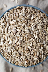 Raw Organic Sunflower Seed Kernels in a Blue Bowl, top view. Flat lay, overhead, from above. Close-up.
