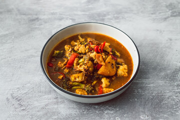 healthy plant-based food, vegetable stew with cauliflower potato broccoli in spicy broth