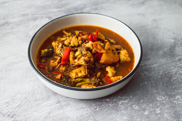 healthy plant-based food, vegetable stew with cauliflower potato broccoli in spicy broth