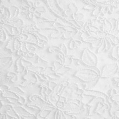 White lace fabric with a floral ornament. A feminine background best for romantic invitations, bridal shower or wedding designs.