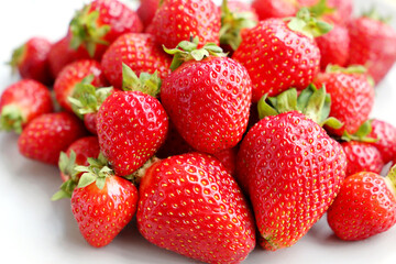 Fresh red strawberries with leaves. Pile of ripe strawberry for background