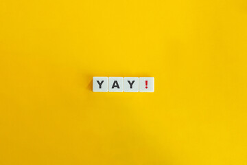 Yay Exclamation on Letter Tiles on Yellow Background. Minimal Aesthetics.