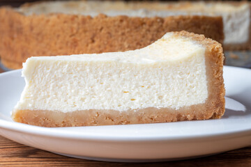Cheesecake slice. Classical New York cheese cake on wooden background
