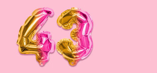 Rainbow foil balloon number, digit forty three on a pink background. Birthday greeting card with inscription 43. Top view. Numerical digit. Celebration event, template. Banner