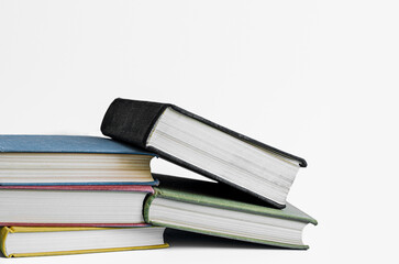 Stack of books on white background with copy space