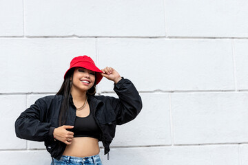 Young latin woman hip hop dancing in the street with a red hat, Panama, Central America - stock photo