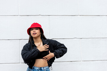 Young latin woman hip hop dancing in the street with a red hat, Panama, Central America - stock photo