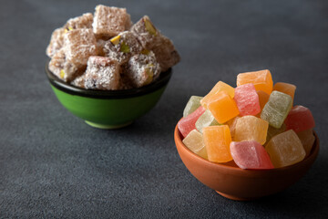 Traditional Turkish delight in two bowls on dark background
