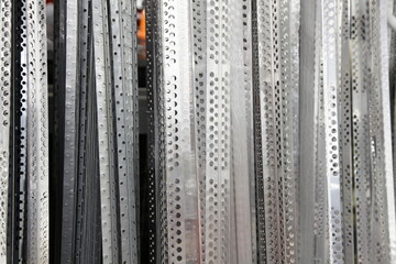 Plastering rebars - vertical perforated metal stripes industrial background texture