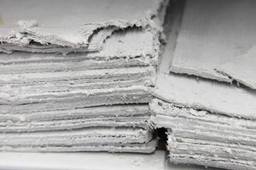 Asbestos sheets in stack - effective insulator for construction