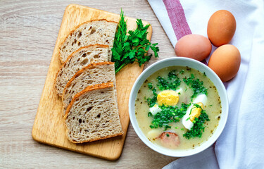 One bowl of Żurek soup is a festive traditional Polish soup. Delicious hot soup with egg and...