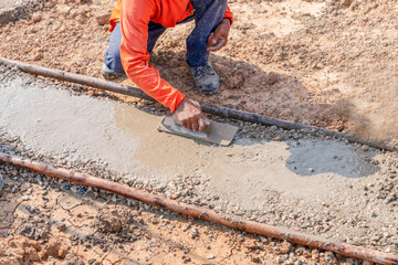 Worker use plasterize lean concrete for prepare steel rebar foundation.