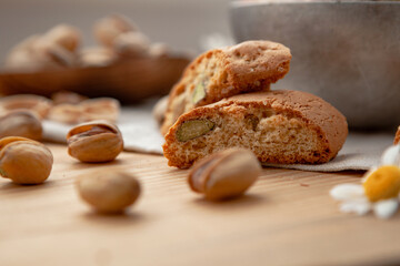 Pistachios and some cantucci on a wooden table
