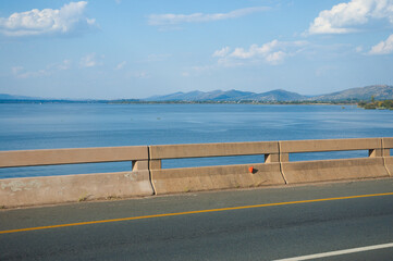 empty road bridge with a dam in the background