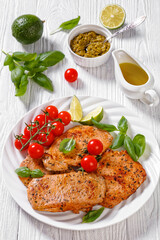 tomato basil pesto fried pork cutlets on plate