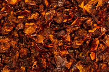 Dried and sun dried tomatoes closeup, flat lay background. Indian and Arabic spices for cooking. Medicinal herbs and condiment.