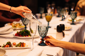 mineral water is poured into a glass of blue glass. soft drinks