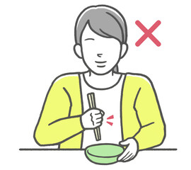 お箸のマナー違反　握り箸をする女性