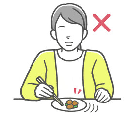 お箸のマナー違反　寄せ箸をする女性