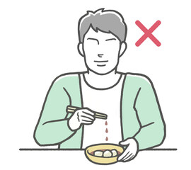 お箸のマナー違反　涙箸をする男性