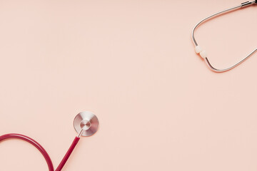Medical stethoscope isolated on pink background with copy space. Treatment and diagnostic concept