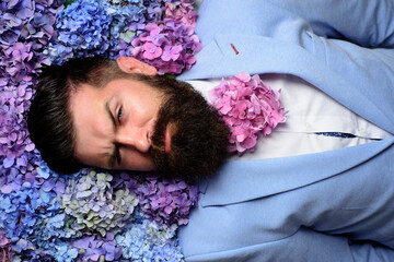 Bearded man with beard in flower in beard, bearded gay. Barbershop concept. Mustache men.