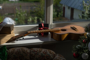 guitar with Christmas presents. Concept image for holiday musical event.