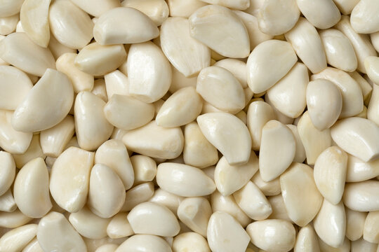 Fresh whole peeled garlic cloves full frame close up