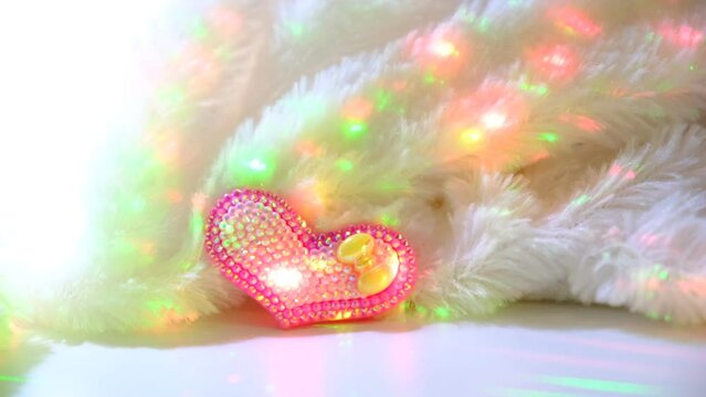 Festive holiday background with heart and warm plaid.  Details interior of bedroom for little princess girl. Decorating baby bedroom. 