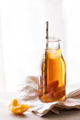 Homemade peach and lemon ice tea with mint on rustic background