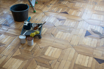 Renovated brown oak parquet, Reconstruction old house symbol, Wooden oak parquet floor background.