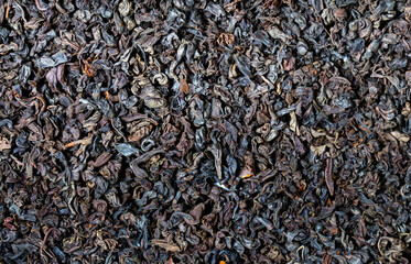 Dried black tea leaves close up as a background. Flower tea, useful herbs for brewing a drink.