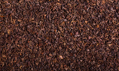 Dried black tea leaves close up as a background. Flower tea, useful herbs for brewing a drink.