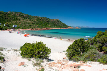 Su Sirboni beach, Sardinia. Marina di Gairo. Crystal clear waters with white sand and red rocks and junipers