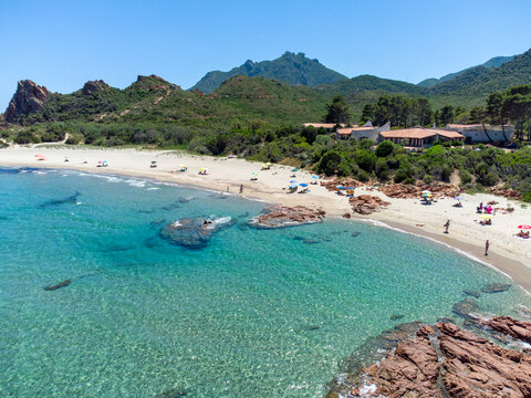 view from the drone of Su Sirboni beach, Sardinia. Marina di Gairo. Crystal clear waters with white sand and red rocks and junipers