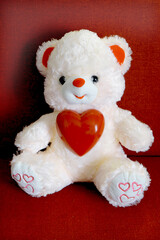 Toy bear with a heart.  Preparation for a romantic holiday at home, soft morning light. Valentines Day, Birthday  and love Concept