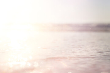 background of blurred beach and sea waves with bokeh lights