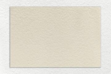 Texture of craft beige paper background with white border, macro. Structure of vintage cardboard with empty cream frame.