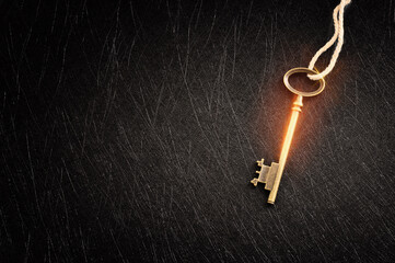 Golden key with glowing lights and dark background, wisdom, wealth, and spiritual concept