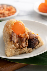 Zongzi, rice dumpling for Dragon Boat Festival on bright marble table background with ingredient.