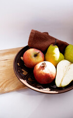 fruit on a plate. Apple. pear. Garnet.